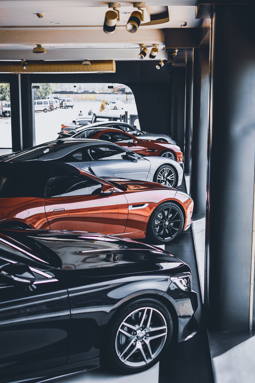 five assorted color cars parked inside room